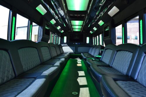 Seats: Up to 50 passengers *Ideal for 40 passengers*  Vehicle Color: White  Amenities:  LED Lighting Upgraded Audio with Bluetooth Built-in Cooler with Cup Holders Video Monitor with CD/DVD playback Rear Climate Control Rear Audio Control  Long Description:  Ford F750 limo bus. Seats up to 50 passengers. Ideal for 40 adults. Comes equipped with wrap around leather seating, hardwood flooring, 1 bar area with built in cooler, colorful LED lighting, 4 large flat screen TVs, and updated audio system with Bluetooth connectivity.