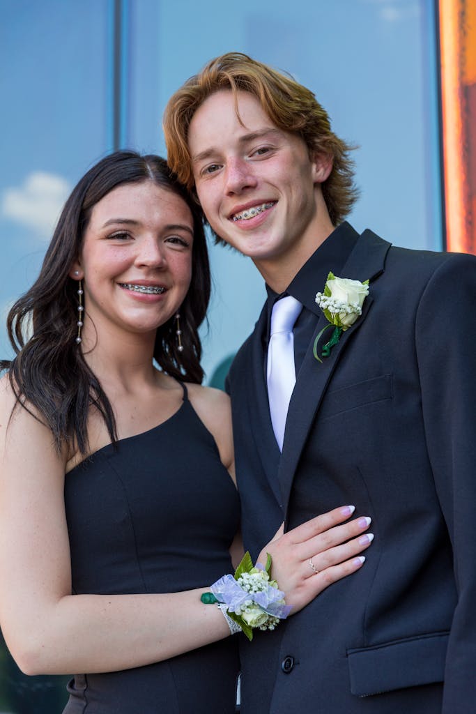 A young man and woman in formal wear